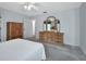 Bedroom with wood dresser and an open door to the home's interior at 25305 Mardon Cir, Paisley, FL 32767