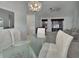 Open-concept dining area with glass table, connecting to the living room at 25305 Mardon Cir, Paisley, FL 32767