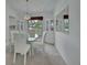 Bright dining room featuring a glass table, white chairs, and built-in cabinets at 25305 Mardon Cir, Paisley, FL 32767