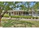 Welcoming single-story home showcasing a delightful screened-in porch and a well-manicured front yard at 25305 Mardon Cir, Paisley, FL 32767