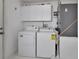 Laundry room with a side-by-side washer and dryer and storage cabinets at 25305 Mardon Cir, Paisley, FL 32767