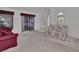 Bright living room with sliders leading to the patio, neutral carpet and comfortable seating at 25305 Mardon Cir, Paisley, FL 32767