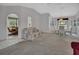 Spacious living room featuring neutral carpeting, comfortable seating, and seamless access to the dining area at 25305 Mardon Cir, Paisley, FL 32767