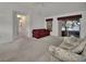 Inviting living room with sliding door access to screened porch; features neutral carpeting and comfortable seating at 25305 Mardon Cir, Paisley, FL 32767