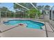 Sparkling swimming pool surrounded by a screened enclosure and patio area at 25305 Mardon Cir, Paisley, FL 32767