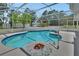 Beautiful pool with a screened enclosure, landscaping, and patio at 25305 Mardon Cir, Paisley, FL 32767