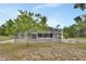 Screened-in pool with spacious deck, perfect for entertaining, overlooking the lush backyard landscape at 25305 Mardon Cir, Paisley, FL 32767