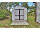 Backyard shed featuring ample storage space with double doors and a neutral color that blends with the outdoors at 25305 Mardon Cir, Paisley, FL 32767