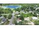 An aerial view of a home with a large lake and lush greenery in the background at 28045 Poinsettia Ave, Paisley, FL 32767