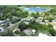 An aerial view showcasing a neighborhood with a nearby lake, lush greenery, and well-maintained streets at 28045 Poinsettia Ave, Paisley, FL 32767