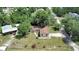 Overhead view of the property showcasing the house, yard, and surrounding area at 28045 Poinsettia Ave, Paisley, FL 32767