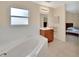 Bright bathroom features a large tub, vanity with mirror, and tiled floors at 28045 Poinsettia Ave, Paisley, FL 32767