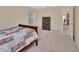 Cozy bedroom featuring carpet, a window with blinds and an open doorway at 28045 Poinsettia Ave, Paisley, FL 32767
