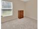 Carpeted bedroom has a window with blinds and a three drawer dresser at 28045 Poinsettia Ave, Paisley, FL 32767