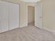 Neutral bedroom with carpet, double door closet and view into hallway at 28045 Poinsettia Ave, Paisley, FL 32767