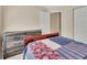 Bedroom with neutral paint, carpet, chest of drawers, and floral quilt at 28045 Poinsettia Ave, Paisley, FL 32767