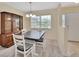 Dining area with table, chairs and buffet cabinet with window and natural lighting at 28045 Poinsettia Ave, Paisley, FL 32767