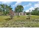 Quaint single-Gathering home with a spacious lawn and flowering bushes at 28045 Poinsettia Ave, Paisley, FL 32767