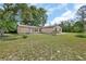 Charming single story home with a well-maintained lawn and landscaping at 28045 Poinsettia Ave, Paisley, FL 32767