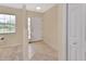 Bright foyer with neutral tile flooring, closet and front door with sidelights at 28045 Poinsettia Ave, Paisley, FL 32767