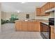 Kitchen with stainless steel sink and oven overlooking the living room and dining area at 28045 Poinsettia Ave, Paisley, FL 32767