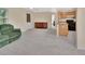 Open living area featuring carpet, a ceiling fan, and natural light at 28045 Poinsettia Ave, Paisley, FL 32767