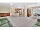 Bright living area with carpet flooring that leads into dining area at 28045 Poinsettia Ave, Paisley, FL 32767