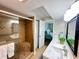 Bathroom showcasing glass-enclosed shower, tile, and granite vanity at 2860 Ocean Shore Blvd # 5020, Ormond Beach, FL 32176