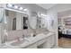 Bathroom featuring a double sink vanity, neutral color scheme, and decorative mirrors at 3 Sea Dance Ter, Ormond Beach, FL 32176