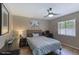 Well-lit bedroom with a ceiling fan, desk area, and a large window at 3 Sea Dance Ter, Ormond Beach, FL 32176
