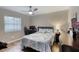 Well-lit bedroom with a comfortable bed, desk, and window at 3 Sea Dance Ter, Ormond Beach, FL 32176