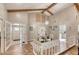 Bright dining area boasts vaulted ceiling, wooden beams, and modern chandelier above the elegant dining table at 3 Sea Dance Ter, Ormond Beach, FL 32176