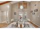 Bright dining area boasts vaulted ceiling and modern chandelier above the elegant dining table and white chairs at 3 Sea Dance Ter, Ormond Beach, FL 32176