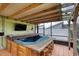 Screened-in patio with a hot tub and bar top seating at 3 Sea Dance Ter, Ormond Beach, FL 32176