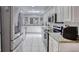 Modern kitchen with stainless steel appliances, granite counters, and bright white cabinets at 3 Sea Dance Ter, Ormond Beach, FL 32176