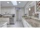 Bright kitchen features granite countertops, white cabinets, stainless steel appliances, and ample counter space at 3 Sea Dance Ter, Ormond Beach, FL 32176