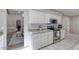 Bright kitchen with white cabinets, stone countertops, and stainless steel appliances at 3 Sea Dance Ter, Ormond Beach, FL 32176