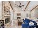 Bright living room features a cozy blue sofa, fireplace, and an open dining area with a modern chandelier at 3 Sea Dance Ter, Ormond Beach, FL 32176