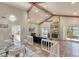 Open-concept living area featuring stone fireplace, vaulted ceiling with beams, and stylish furnishings at 3 Sea Dance Ter, Ormond Beach, FL 32176