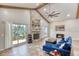 Bright living room features a cozy blue sofa, fireplace, and sliding glass doors to the outdoor space at 3 Sea Dance Ter, Ormond Beach, FL 32176