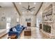 Bright living room features a cozy blue sofa, fireplace, and an open dining area with a modern chandelier at 3 Sea Dance Ter, Ormond Beach, FL 32176