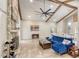 Open-concept living area features stone fireplace, vaulted ceiling with beams, and stylish blue furnishings at 3 Sea Dance Ter, Ormond Beach, FL 32176