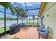 Enclosed patio area with brick flooring featuring comfortable seating and view of the backyard at 3 Sea Dance Ter, Ormond Beach, FL 32176