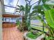 Enclosed patio with lush tropical landscaping and wooden hot tub at 3 Sea Dance Ter, Ormond Beach, FL 32176