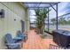Enclosed patio with tile floors, seating, and lush tropical landscaping at 3 Sea Dance Ter, Ormond Beach, FL 32176