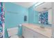 This bathroom features blue walls, a single sink vanity, a toilet, and a shower with patterned curtains at 3051 S Atlantic Ave # 1003, Daytona Beach, FL 32118