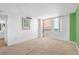This empty bedroom features carpet, balcony access, a picture frame, and an ensuite bathroom at 3051 S Atlantic Ave # 1003, Daytona Beach, FL 32118
