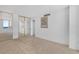 This empty bedroom features mirrored closets, carpet flooring, balcony access and a picture frame at 3051 S Atlantic Ave # 1003, Daytona Beach, FL 32118