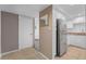 Galley kitchen with stainless appliances and tan countertops at 3051 S Atlantic Ave # 1003, Daytona Beach, FL 32118