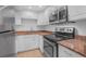 Bright kitchen featuring white cabinets, a stainless steel oven, and tan countertops at 3051 S Atlantic Ave # 1003, Daytona Beach, FL 32118